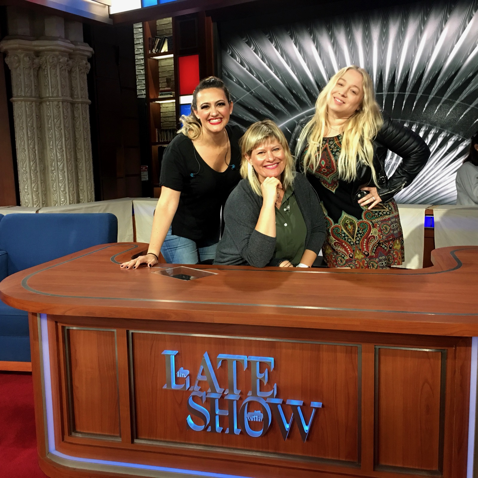 Charissa Nielsen with vocalists at The Late Show desk.