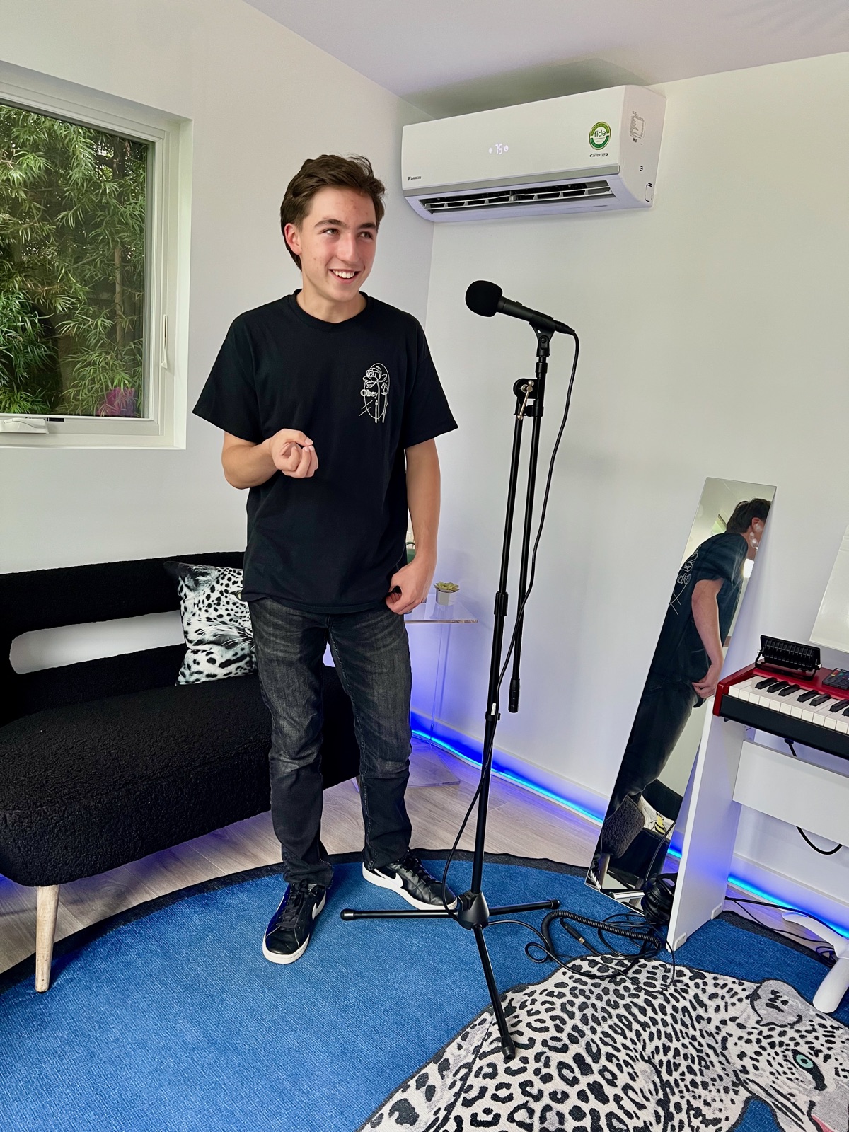 A student singing at the microphone in Studio C