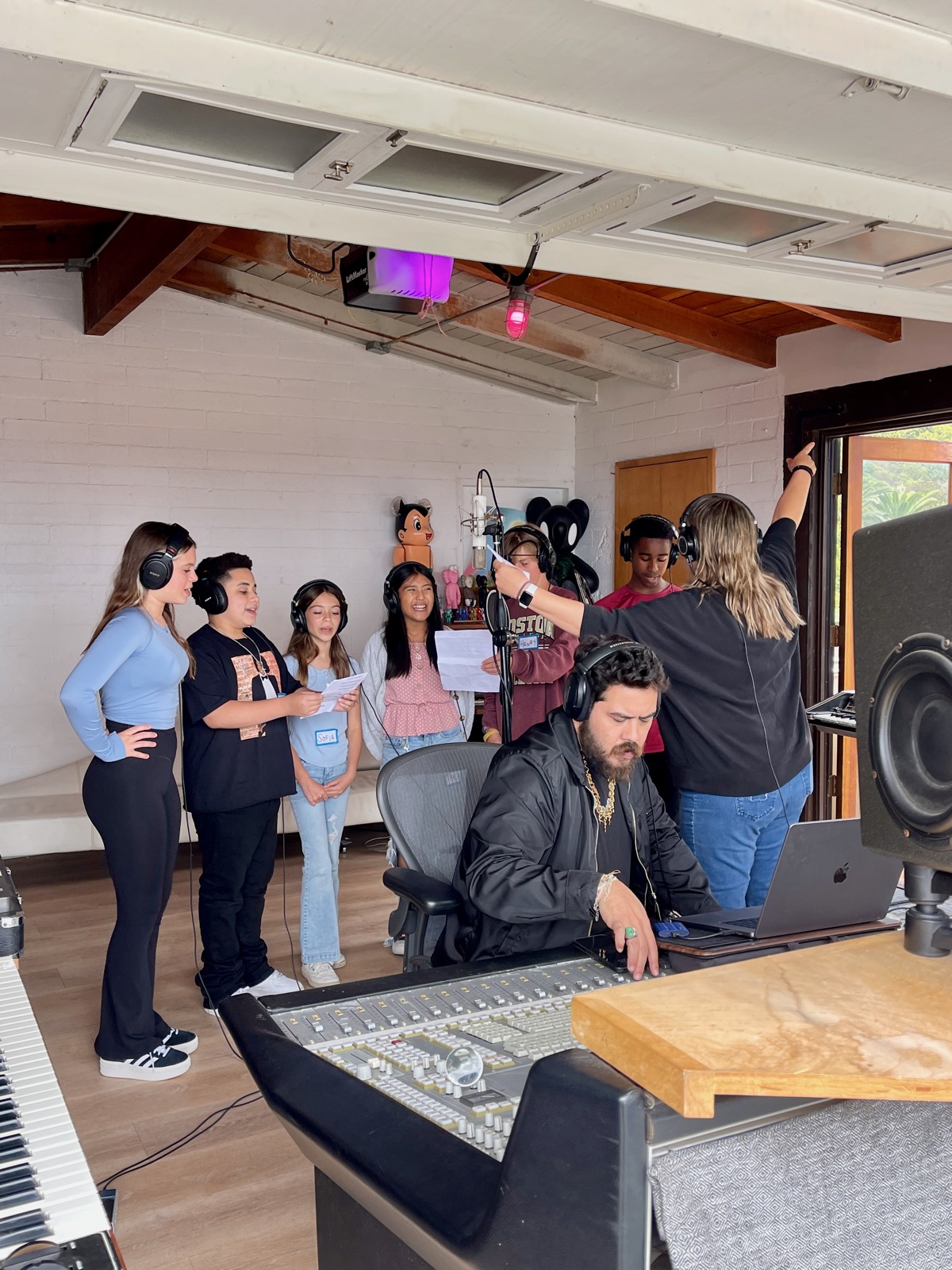 Charissa directing singers around the microphone in a Los Angeles session